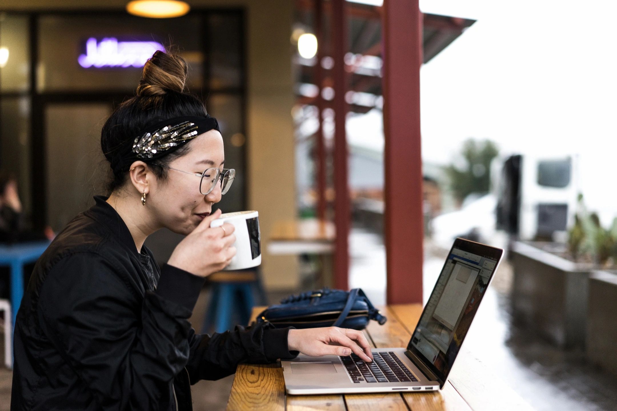 Woman at Laptop Sipping Coffee